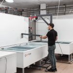 man working with ice block maker